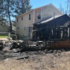 Burned out shed, home with heavy fire damage to its side